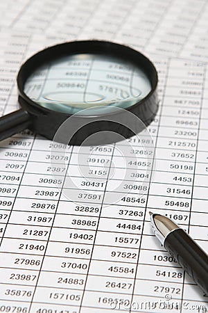 Business concept. Tables with pen and magnifying glass. Stock Photo