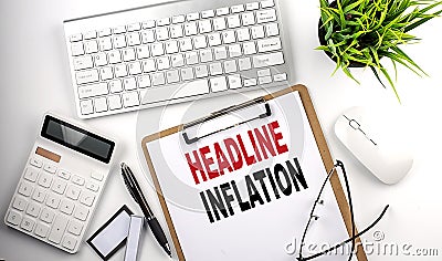 Business concept.Text HEADLINE INFLATION on paper clipboard with,pencil,glasses, keyboard and calculator on white background Stock Photo