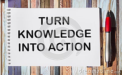 Business concept. On the vintage table lies a notepad with the inscription - Turn knowledge into action Stock Photo