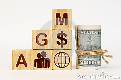 On a white surface, dollars and cubes with images and the inscription - AGM Stock Photo