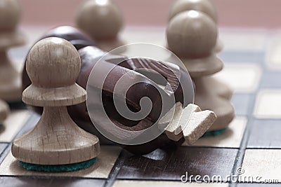 Business concept of win, loss, end of the game. Chessboard and king and pawns. Stock Photo