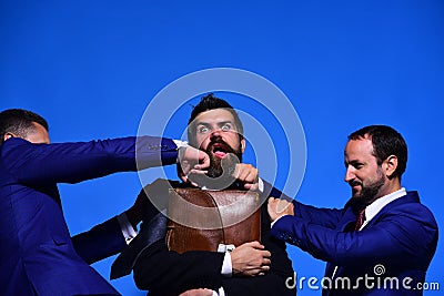 Business conflict. Businessmen and worker with hidden and suffering faces Stock Photo
