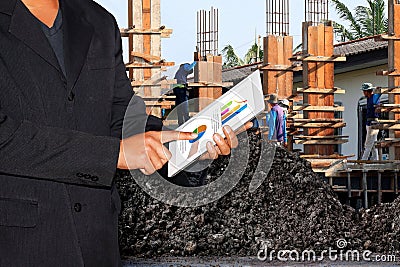 Business Construction Site, Businessman using tablet and Blurred background Construction workers Editorial Stock Photo