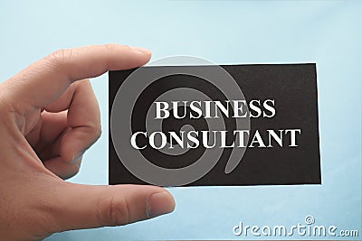 Business consultant, text words typography written on paper against blue background, life and business motivational inspirational Stock Photo