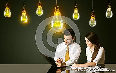 Business couple with idea bulbs Stock Photo
