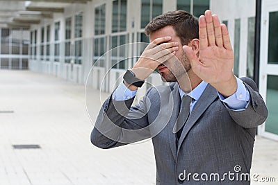 Business covering his eyes to avoid reality Stock Photo