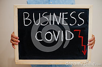 Business covid crisis. Coronavirus concept. Boy hold inscription on the board Stock Photo