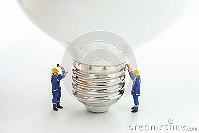 Business creative idea, power or energy generator concept, miniature people figurine engineer worker help building light bulb on Stock Photo