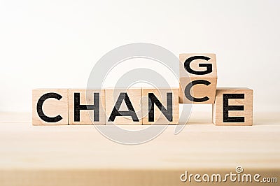 Surreal abstract geometric floating wooden cube with word CHANGE and CHANCE concept on wood floor and white background Stock Photo