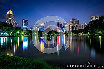 Business district cityscape from a park with twilight time from lumpini park Stock Photo