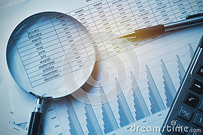 business documents accounting with calculator, pen and magnifying glass. concept for financial Stock Photo