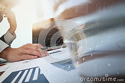 business documents on office table and laptop computer and graph Stock Photo