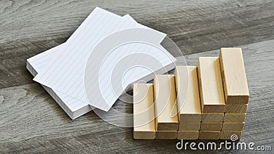 Business / Education Challenge Concept - Blank Index Cards With Stairway Upwards Of Building Blocks Over Dark Wooden Background Stock Photo