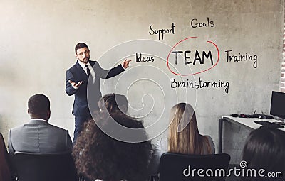 Business education seminar. Man showing teamwork components Stock Photo