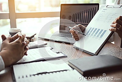 Business employee man are reporting about performance graphs summary and financial budget calculations for managers in the office Stock Photo