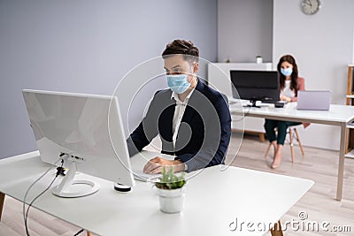 Business Employees In Office Wearing Medical Masks Stock Photo