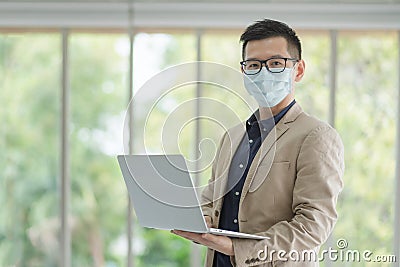 Business employees wearing mask during work in office to keep hygiene follow company policy.Preventive during the period of Stock Photo