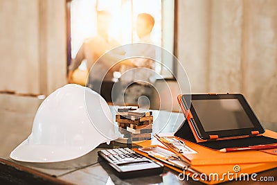 Business engineer working hard at his desk in apartment home building concept at construction site main office. Stock Photo