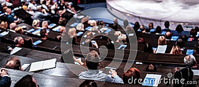 Business and entrepreneurship symposium. Audience in conference hall. Rear view of unrecognized participant in audience. Editorial Stock Photo