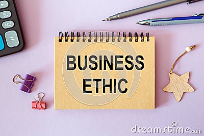 Notebook with text - Business Ethic - near office supplies Stock Photo