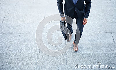 Business executive with briefcase going up the stairs. Stock Photo