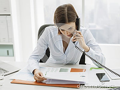 Business executive working in the office and making phone calls Stock Photo