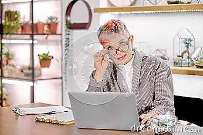 Business female sitting with laptop in light room Stock Photo