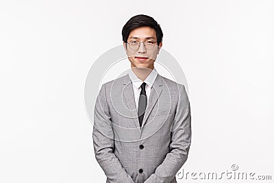 Business, finance and career concept. Portrait of professional handsome young asian man in grey suit and tie, look Stock Photo