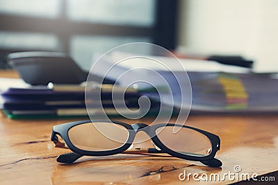 Business and finance concept of office working,Closeup eyeglasses on office desk Stock Photo