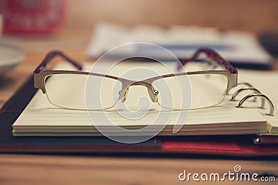 Business and finance concept of office working, Closeup eyeglasses on office desk Stock Photo