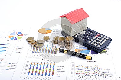 Business finance concept with red house with calculator and fountain pen and money coins on documaent report Stock Photo