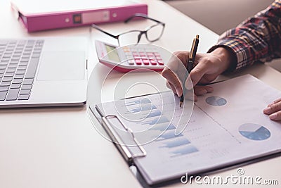 Businessman check about cost and doing finance graph report at office Stock Photo