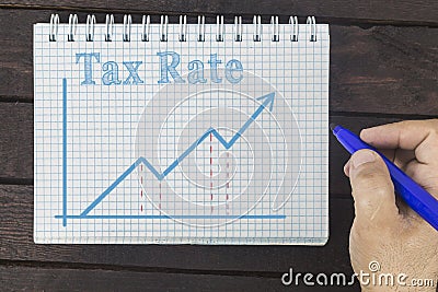 Business, finance, investment, saving and cash concept - business man drawing graph of tax rate Stock Photo