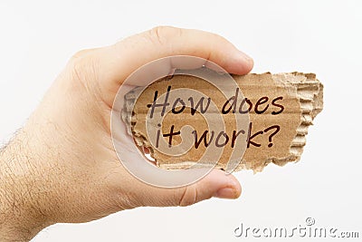 A man holds a cardboard in his hand on which it is written - How does it work Stock Photo