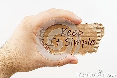 A man holds a cardboard in his hand on which it is written - Keep It Simple Stock Photo