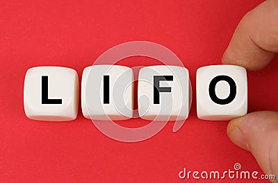On the red surface, white cubes with the inscription - LIFO Stock Photo