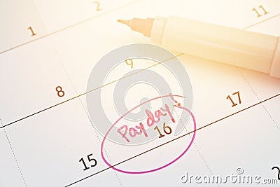 Calendar with pink marker circle in word payday for remind Stock Photo
