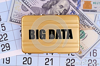 On the table lies a calendar, money and a briefcase with the inscription - BIG DATA Stock Photo