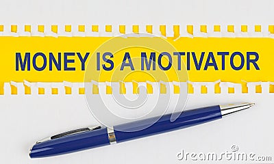 On the table are two sheets from a notebook and a pen on a yellow background written - MONEY IS A MOTIVATOR Stock Photo