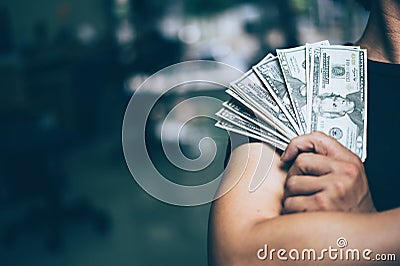 Businessmen hold many banknotes, standing successful businessmen. Stock Photo