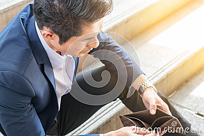business financial concept : sad poor problem businessman holding no money open wallet Stock Photo