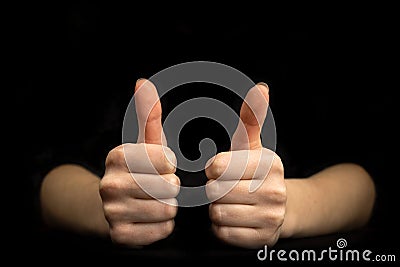 Business gesture. Thumb up close-up. Black background with copy space Stock Photo