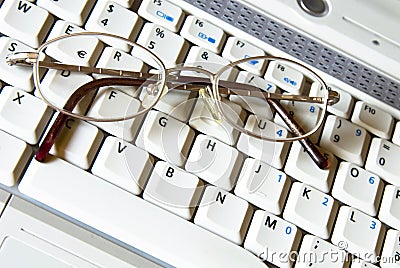 Business glasses on a laptop keyboard Stock Photo