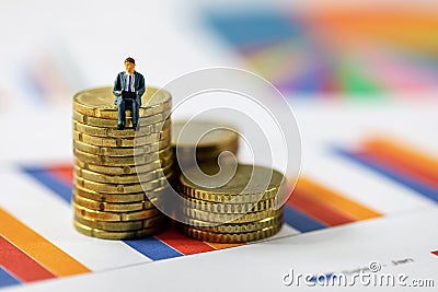 Business growth concept - businessman sitting on coin stack Stock Photo