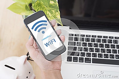 Business hand holding smart phone with Free wifi access Stock Photo