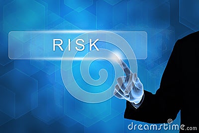 Business hand pushing financial risk button Stock Photo