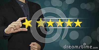 Business hand select yellow marker on five star rating. Stock Photo