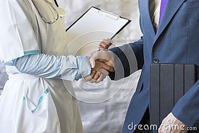 Business handshake. Businessman shaking hands with doctor shaking hands. Stock Photo