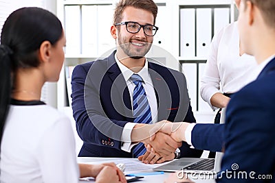 Business handshake at meeting or negotiation in the office. Partners are satisfied because signing contract or financial Stock Photo