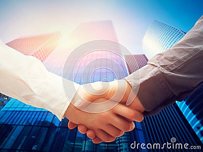 Business handshake, skyscrapers background. Deal, success, cooperation Stock Photo